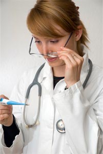 Nurse reading a thermometer